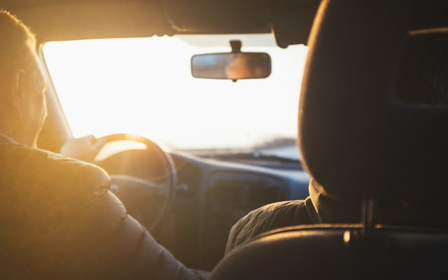 A driver at the wheel during golden hour