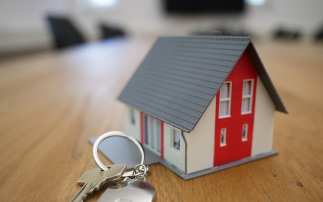 A small wooden model house on a table